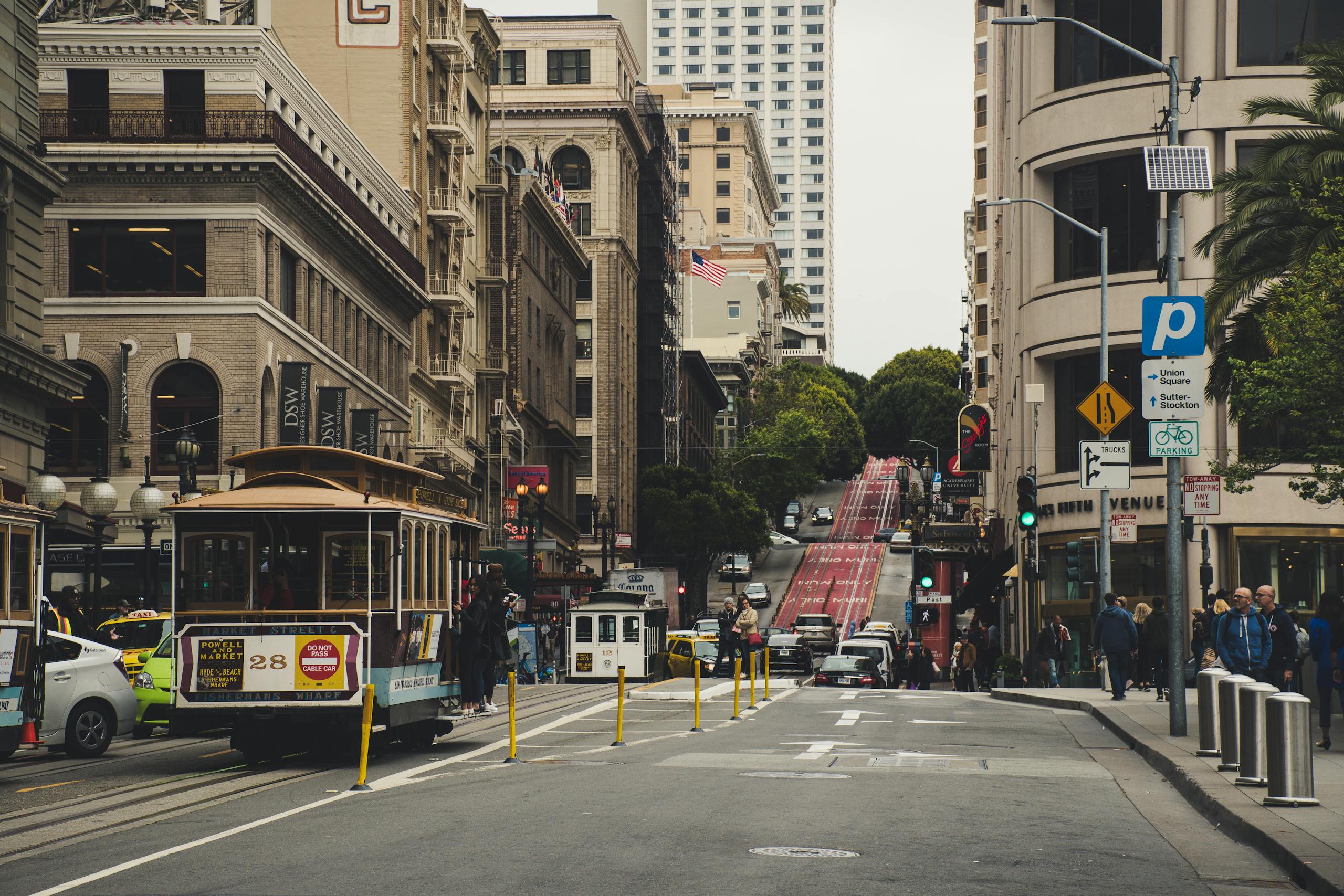 Historic San Francisco street with cable cars and classic architecture. Urban transportation and city life.
